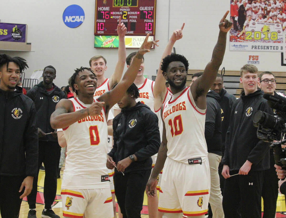 Ferris's Walt Kelser (0) and Dorian Aluyi (10) point to their fans after Thursday's 76-72 overtime victory over Michigan Tech.