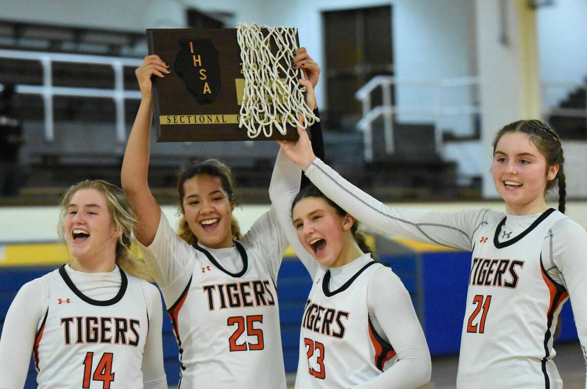 Edwardsville's Emma Garner, Sydney Harris, Macy Silvey and Elle Evans celebrate after winning the Class 4A Joliet Central Sectional championship game on Thursday in Joliet.