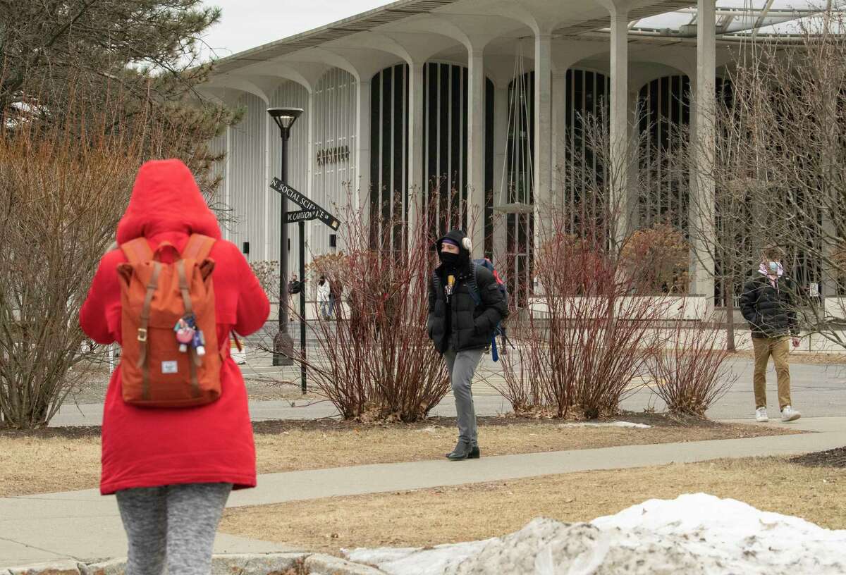 Students are seen walking on campus between classes at University at Albany on Thursday, Feb. 24, 2022 in Albany, N.Y.