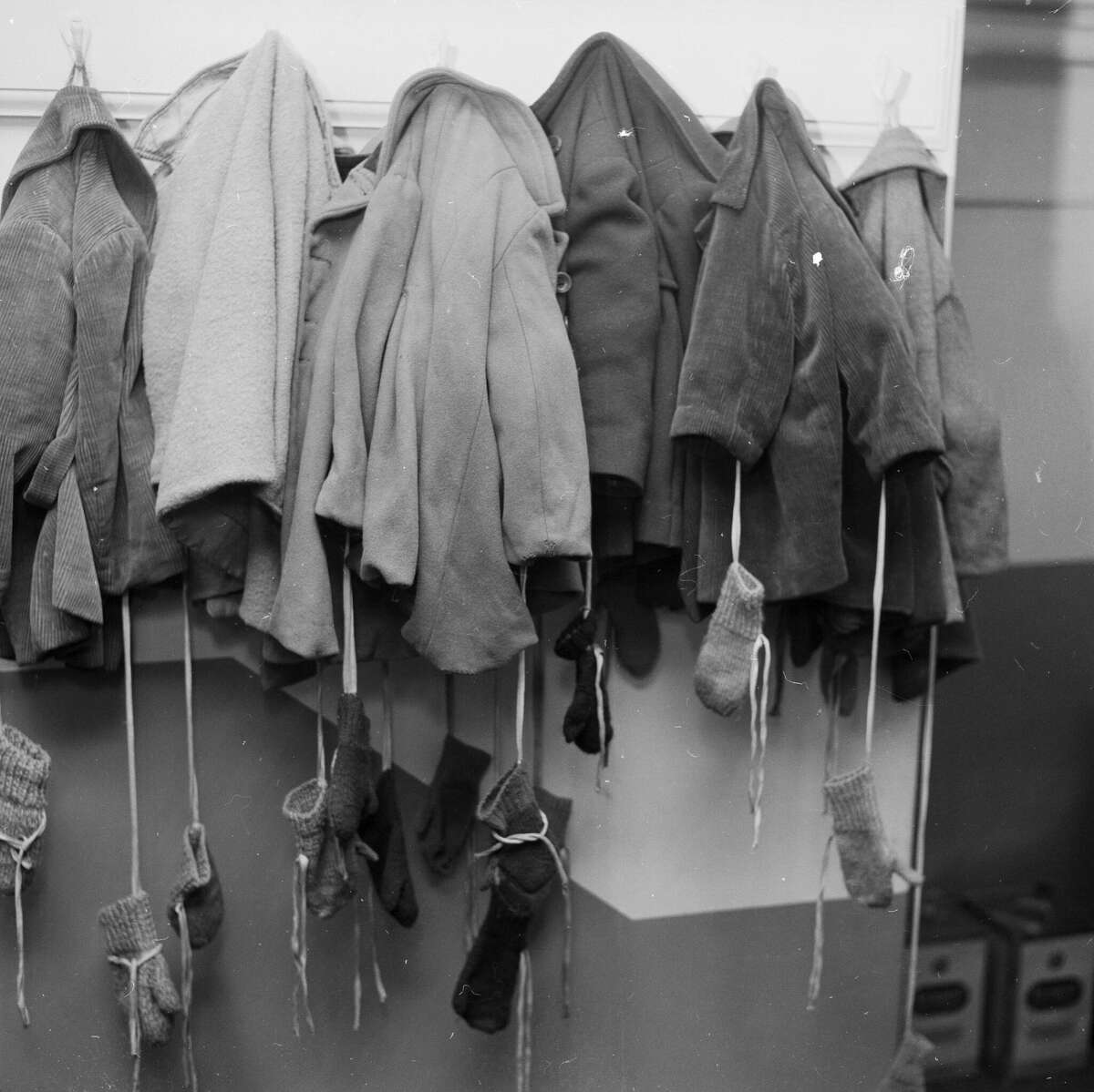 January 1958: A row of small coats and mittens hanging in the locker room of the Holborn Toddlers' Club in London. (Photo by Russell Knight/BIPs/Getty Images)