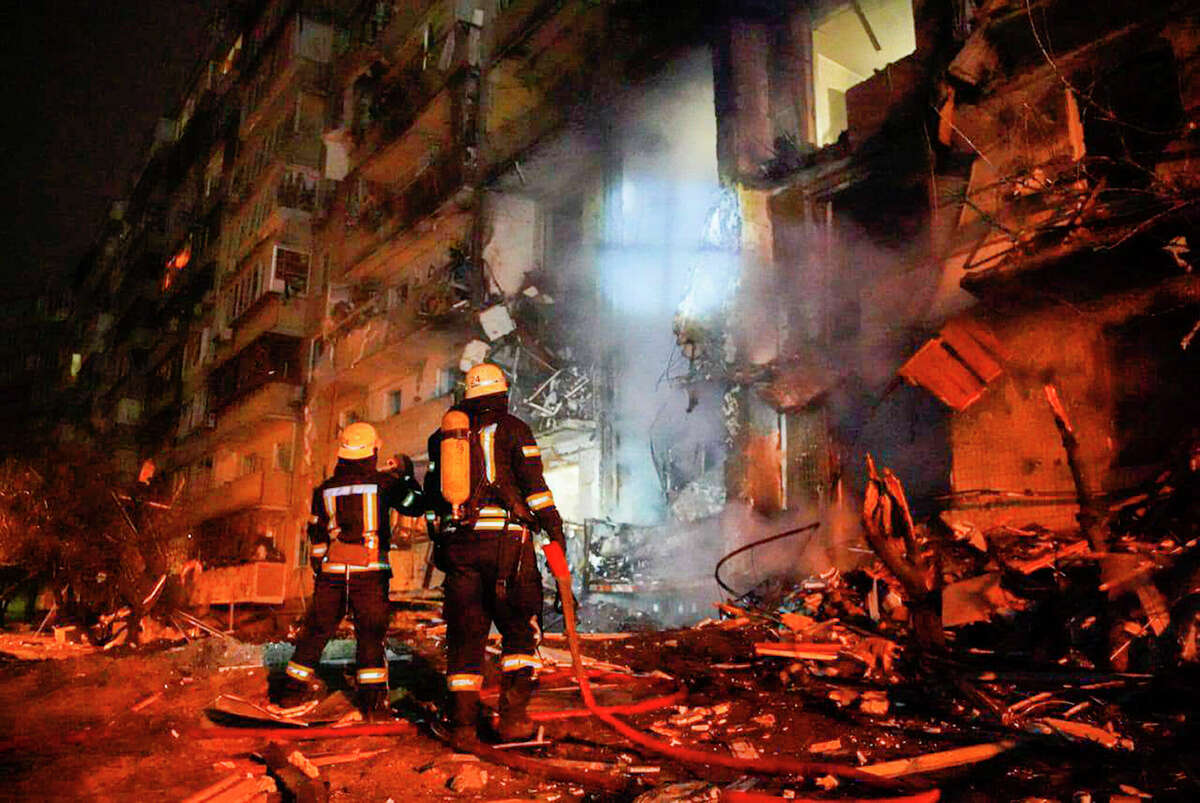 In this handout photo taken from video released by Ukrainian Police Department Press Service released on Friday, Feb. 25, firefighters inspect the damage at a building following a rocket attack on the city of Kyiv, Ukraine, Friday, Feb. 25, 2022. Russia is pressing its invasion of Ukraine to the outskirts of the capital. That comes a day after it unleashed airstrikes on cities and military bases and sent in troops and tanks from three sides.  