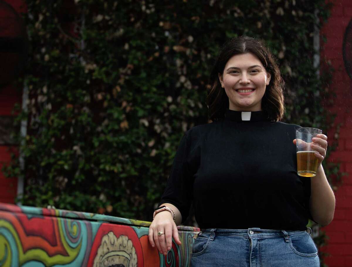 Jordan Czichos, pastor of evangelism at Houston First United Methodist Church, poses for a photograph Wednesday, Feb. 16, 2022, at Platypus Brewing in Houston. Czichos started the youth group called "Where are we Wednesdays.” Members meet at different breweries around Houston and talk about faith over a beer. She will impart ashes at the brewery on Ash Wednesday at 7 p.m.