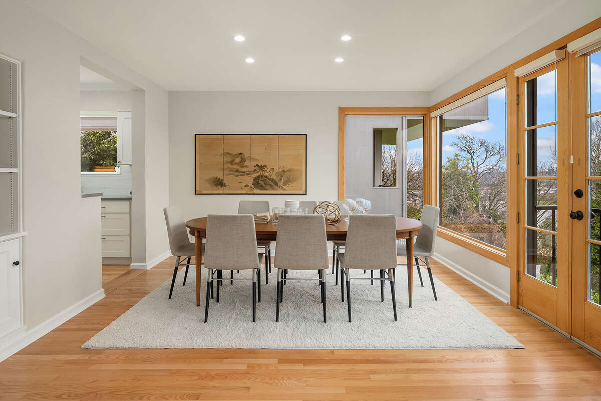 The kitchen opens to this dining room, which in turn opens to a deck.