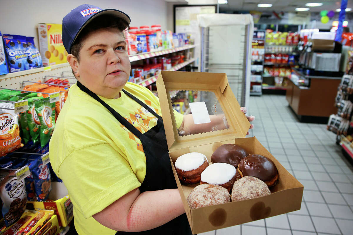 Amanda Tingay holds a box of assorted flavors of paczki at the Wesco in Manistee Township on Feb. 24. Tingay is one of two bakers during the night shift at Wesco. They are staffed 24 hours during paczki day. Tingay notes that they have four or five people to help out baking on paczki to ensure they can be staffed the day before and on paczki day--also known as Fat Tuesday--and Mardi Gras.