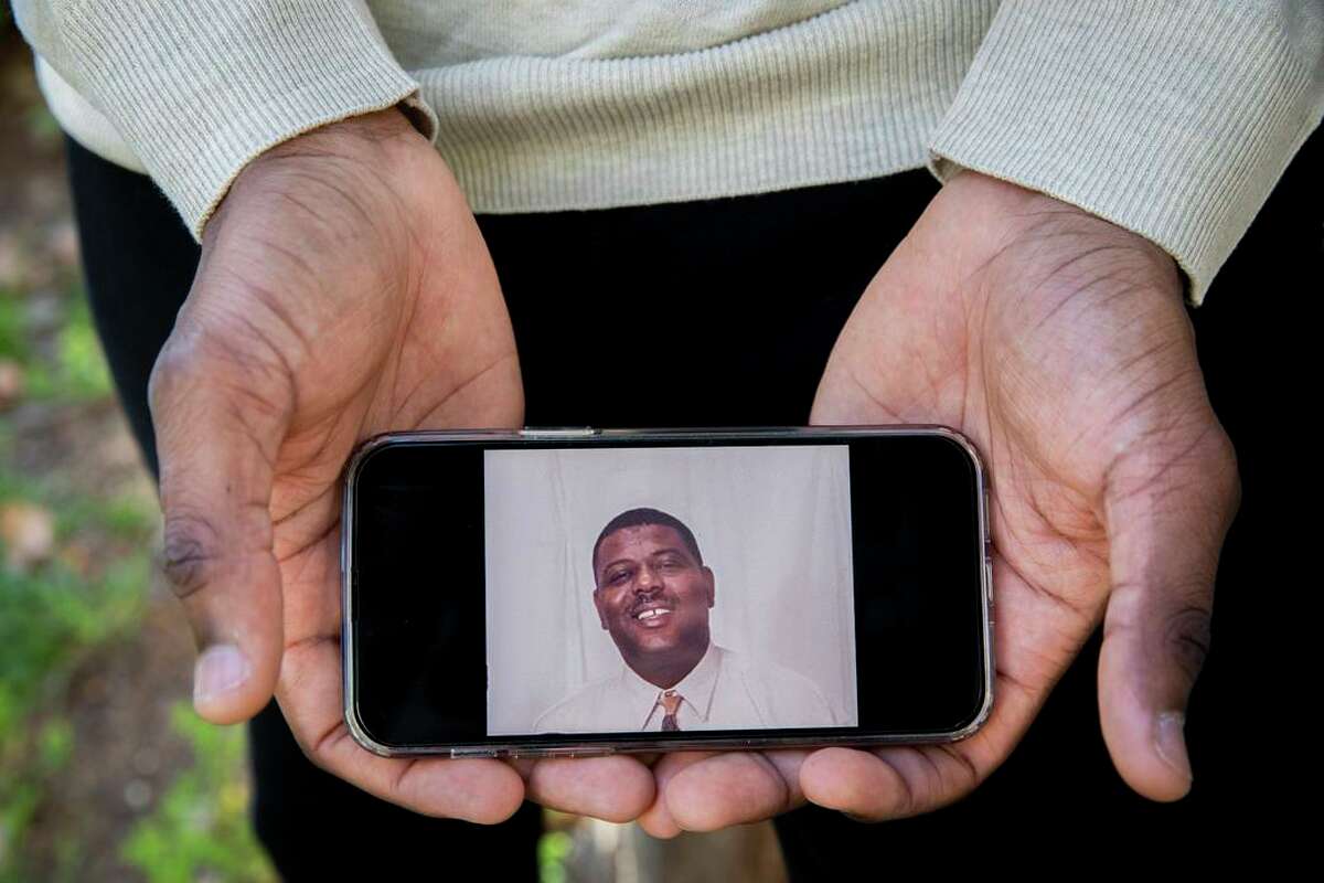 Emmanuel Duverneau holds a photo of his late father Dama Duverneau. During the coronavirus pandemic, Duverneau decided to dedicate herself to her love for cooking in order to honor her late father, who passed away from COVID-19.