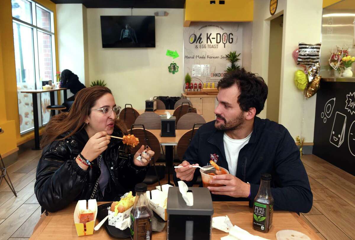 Diciana Hernabes, left, and Michael Bajuz eat at the recently opened Oh K-Dog & Egg Toast on College Street in New Haven Feb. 25, 2022.
