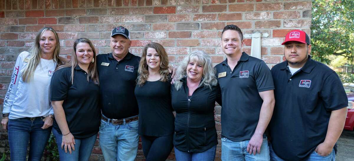 Hughes was happy to share they moment with her daughters Michelle, Paula, Telge Roofing owner Roy Campbell, Candace, Hughes (middle), project manager and claims specialist Joey Shedd, and Crew Chief Adrian Avalos.