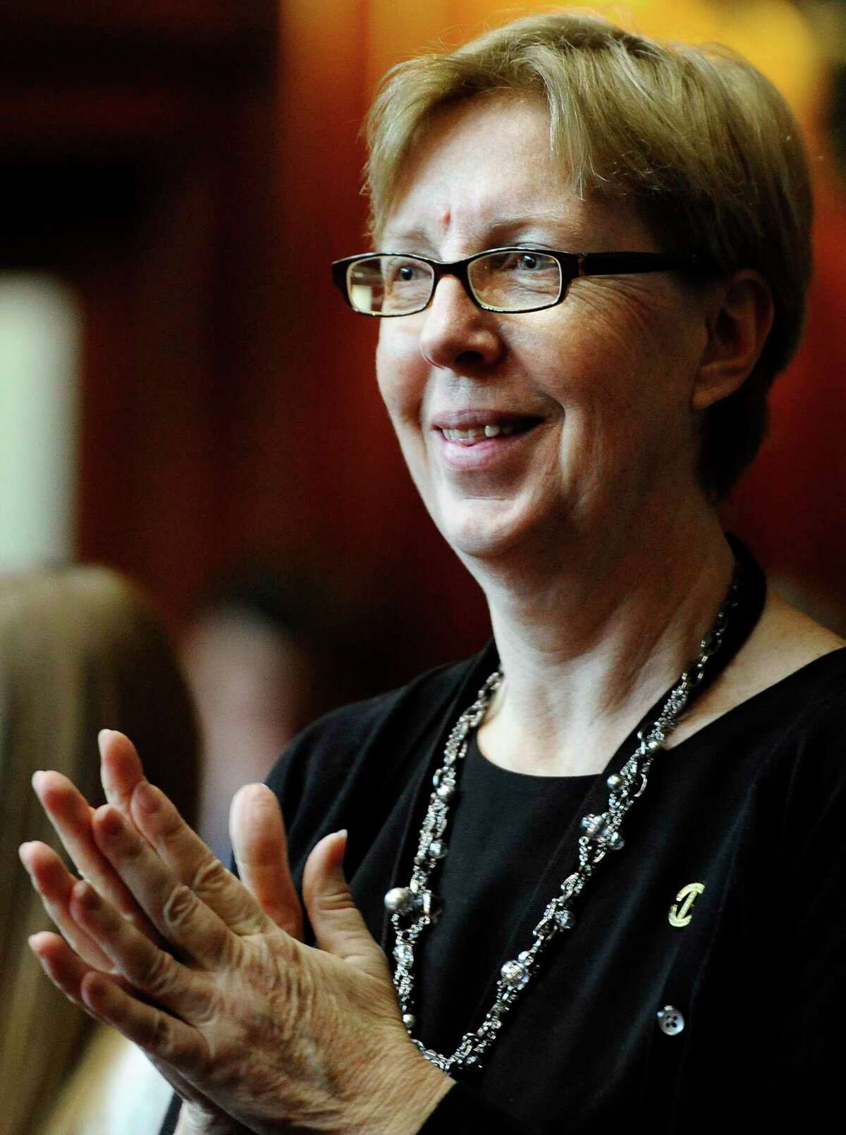 New State Sen. Cathy Osten, D-Sprague, smiles during opening session at the Capitol in Hartford, Conn., Wednesday, Jan. 9, 2013.