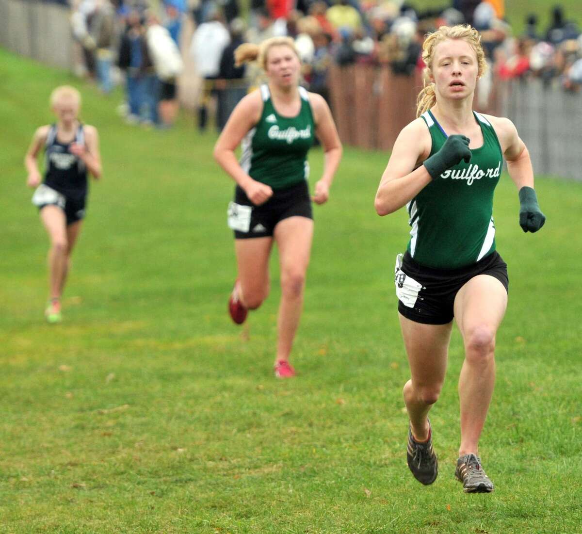 Guilford's Kathleen Ferrall is about to finish second in the Class MM race while teammate Emily Taylor took third. Photo by Peter Hvizdak/Register