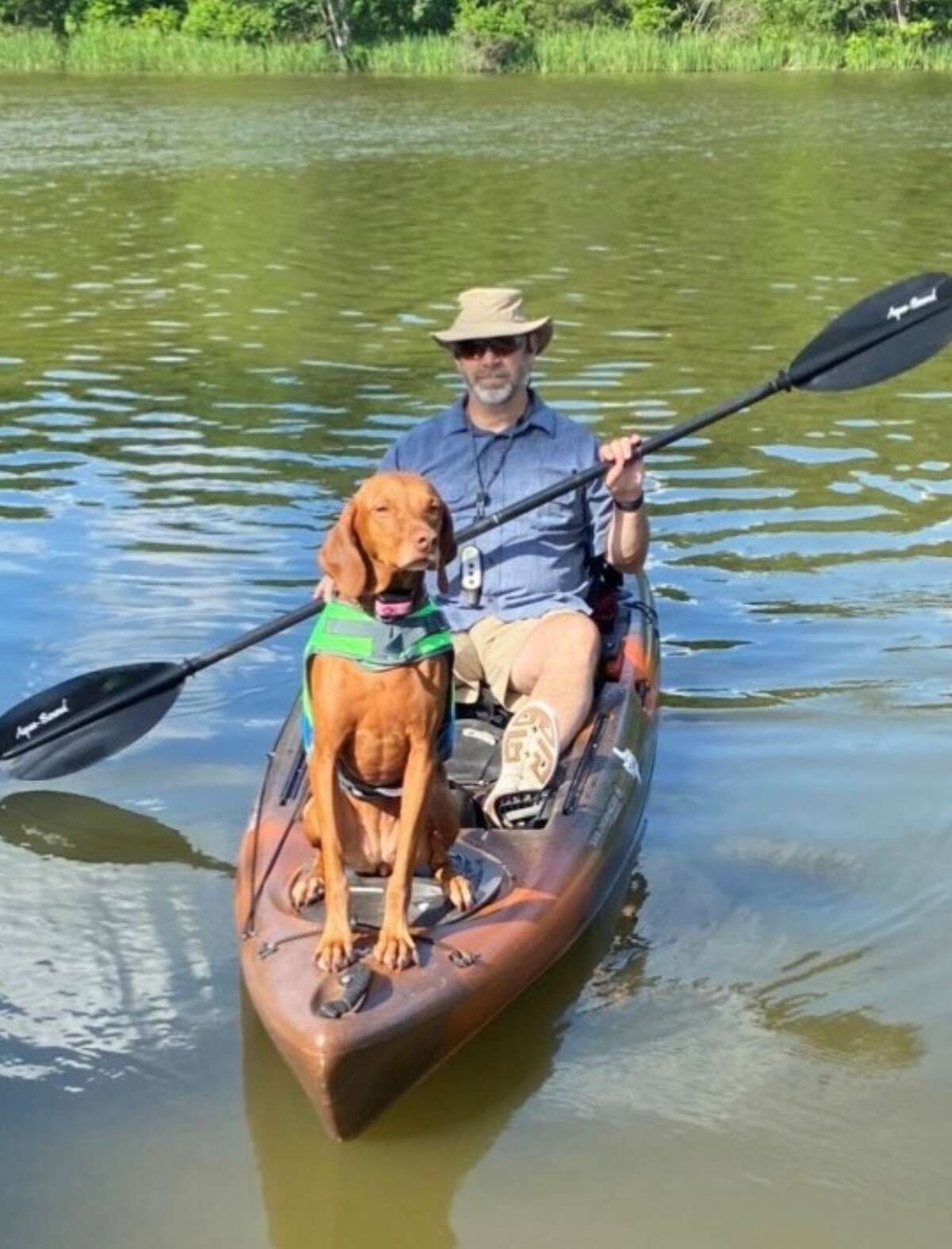 Robert and their dog, Jersey on a kayak