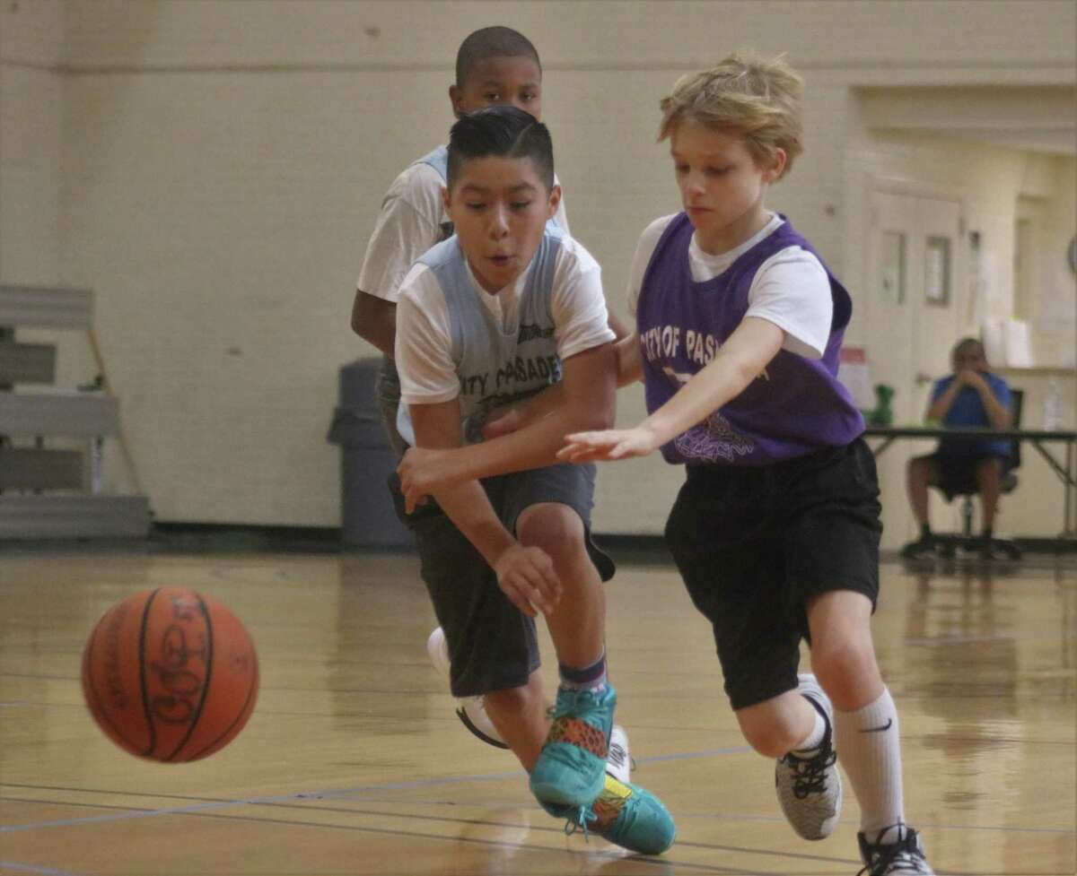 A youth basketball scene from a past campaign at PAL Gym has two players seeking control of the ball. On Saturday, from 8 a.m. to 8 p.m., PAL Gym will host 13 youth playoff games. Those that remain after Saturday head for city title contests on March 5.