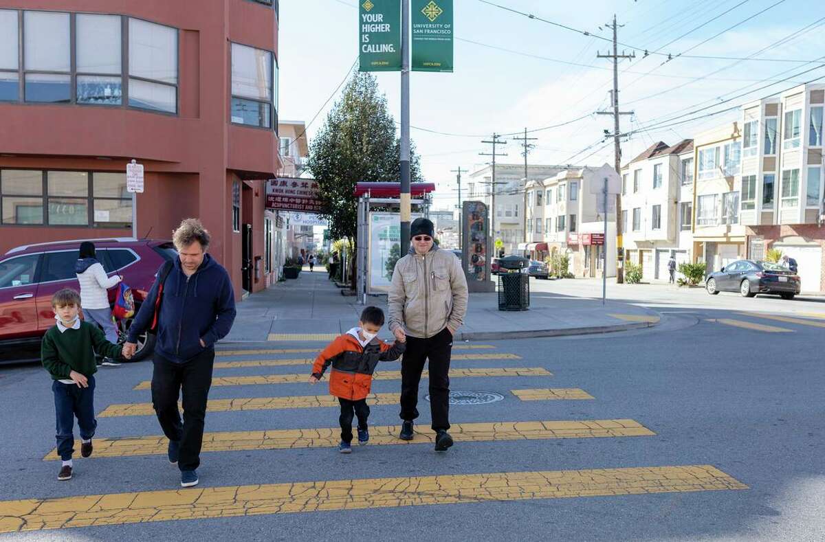 Ilya Rumyantsev (left) and his son, Anatoly, from Russia, walk with their friends Alex Berzhanskiy and his son, Arik, from Ukraine in San Francisco.