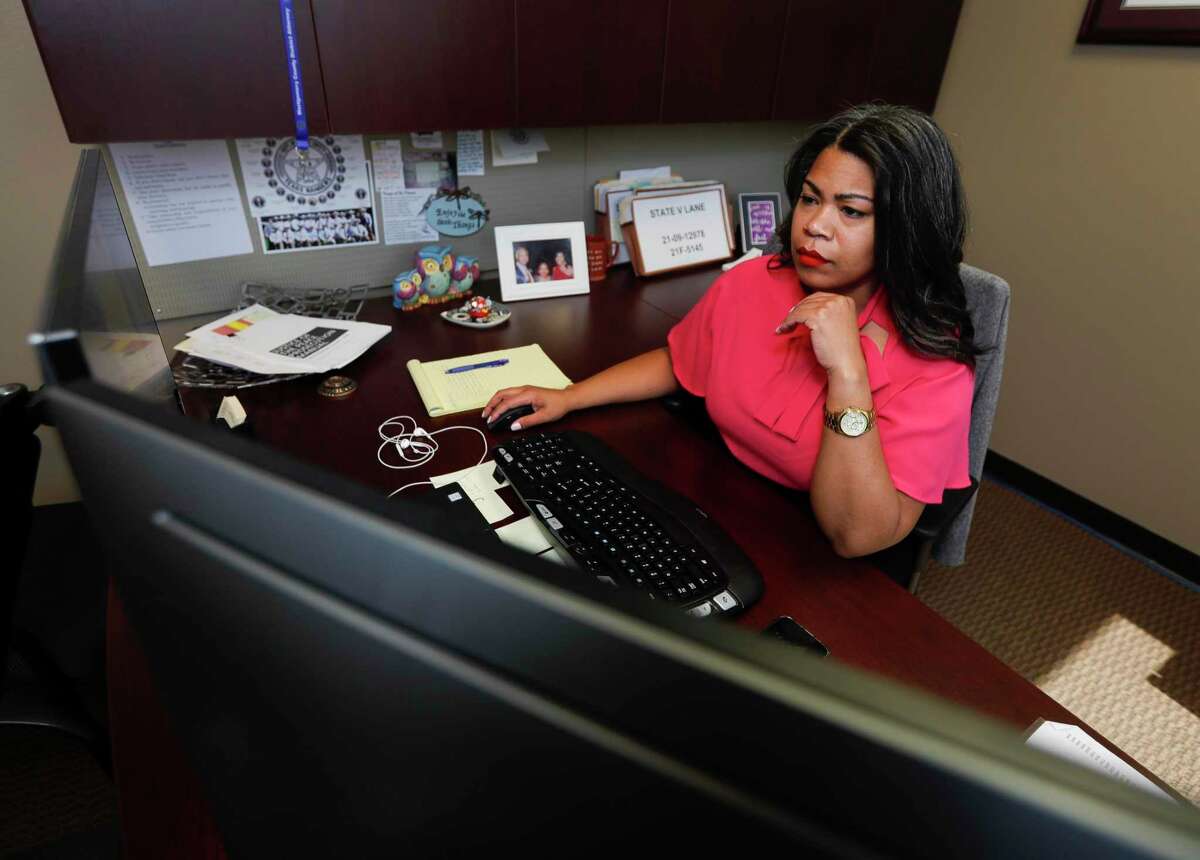 Tiana Sanford, a division chief at the Montgomery County District Attorney’s Office, works at her desk, Thursday, Feb. 18, 2022, in Conroe.