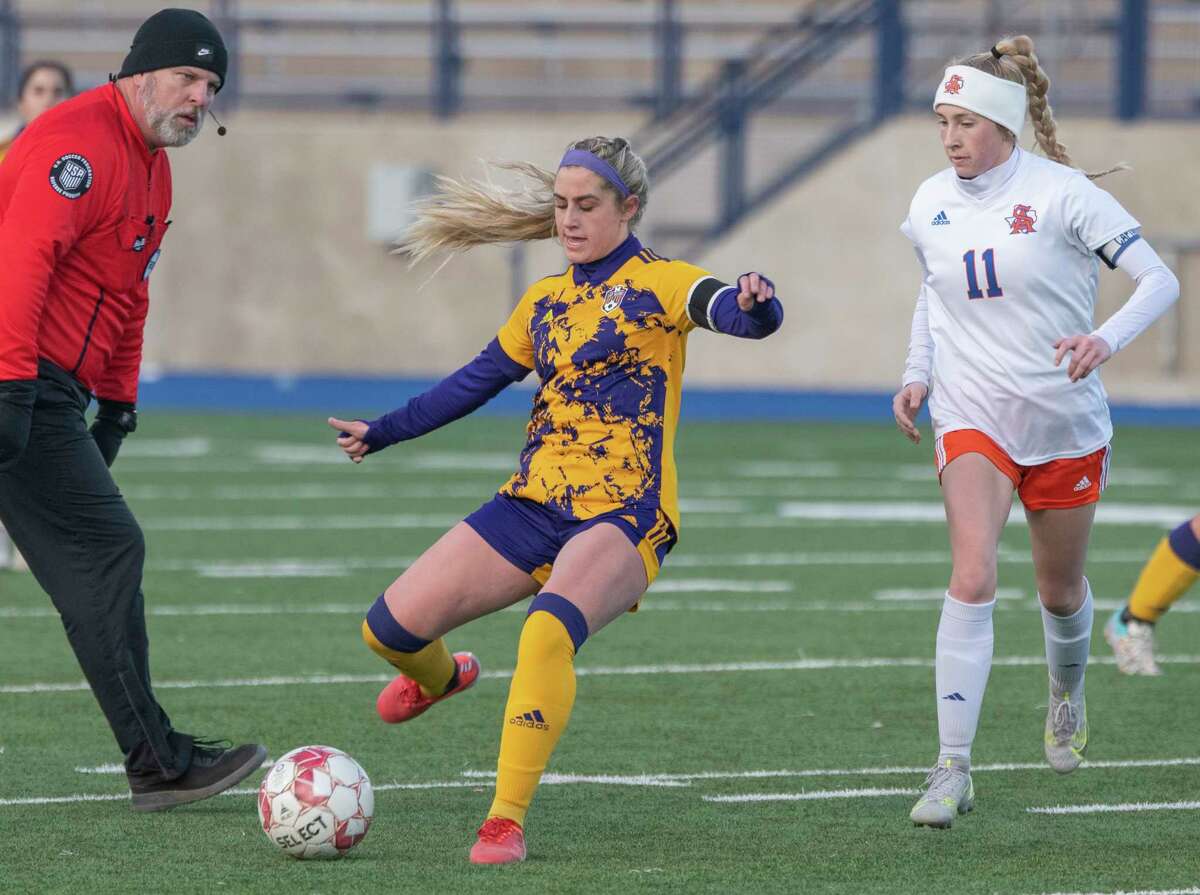Midland High's Kinsey Hill looks to pass as San Angelo Central's Abi Kalnbach comes to defend 02/25/2022 at Grande Communications Stadium. Tim Fischer/Reporter-Telegram