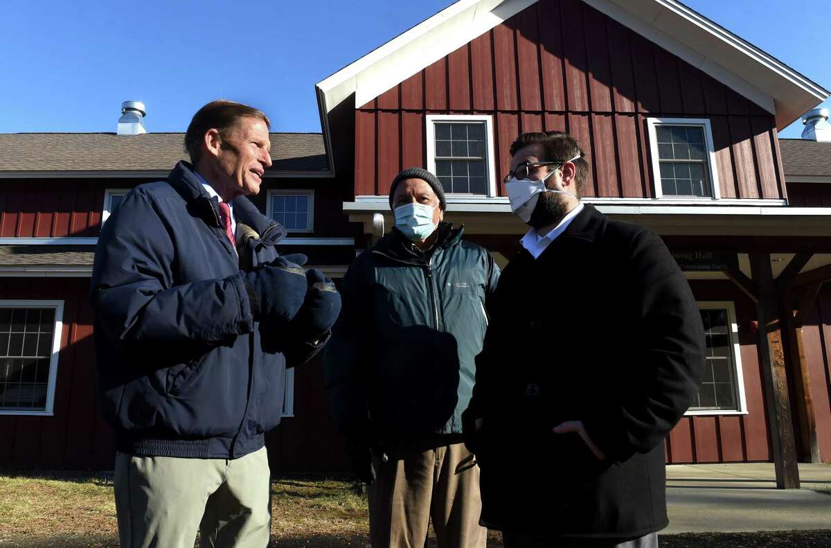 From left, Senator Richard Blumenthal speaks with Rudy Escalante, president of the Boy Scouts of America's Connecticut Yankee Council, and Bob Brown, VP of Marketing for the Connecticut Yankee Council, after a press conference at Deer Lake Scout Reservation in Killingworth on January 27, 2022.