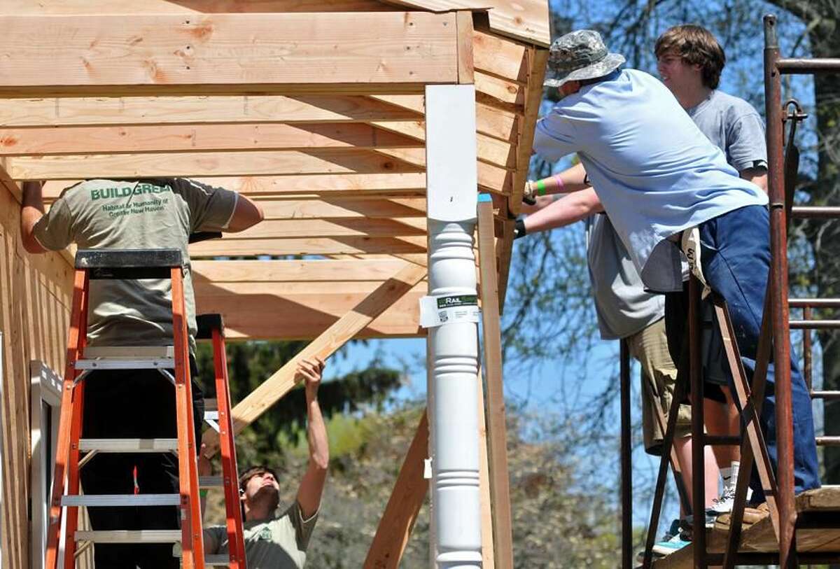 Work team constructs a model porch during a Habitat for Humanity build on the Madison Green. File photo.