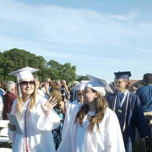 A high school graduate pins a buttoneer on her boyfriend, Providence,  News Photo - Getty Images