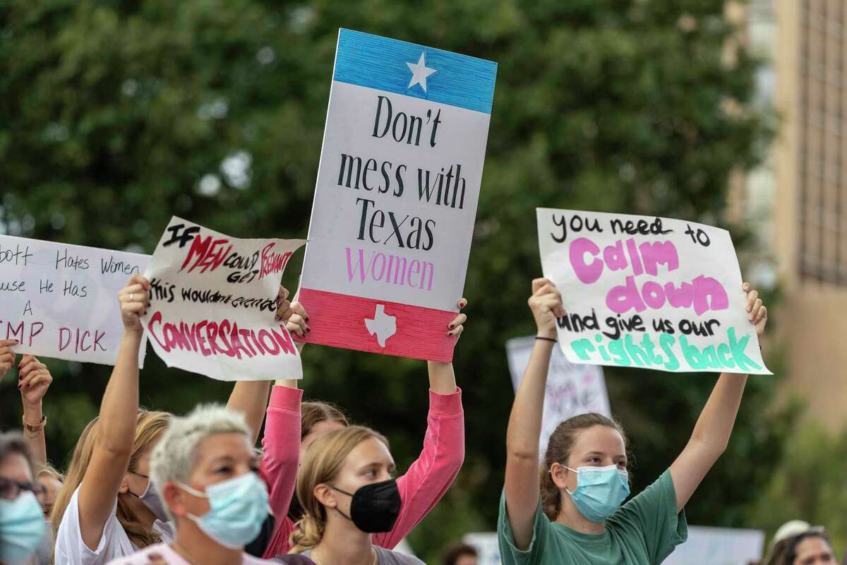 FILE -People take part in the Women's March ATX rally, Saturday, Oct., 2, 2021 in at the Texas State Capitol in Austin, Texas. Texas has released data showing a marked drop in abortions at clinics in the state in the first month under the nation's strictest abortion law, but that only tells part of the story, Friday, Feb. 25, 2022.
