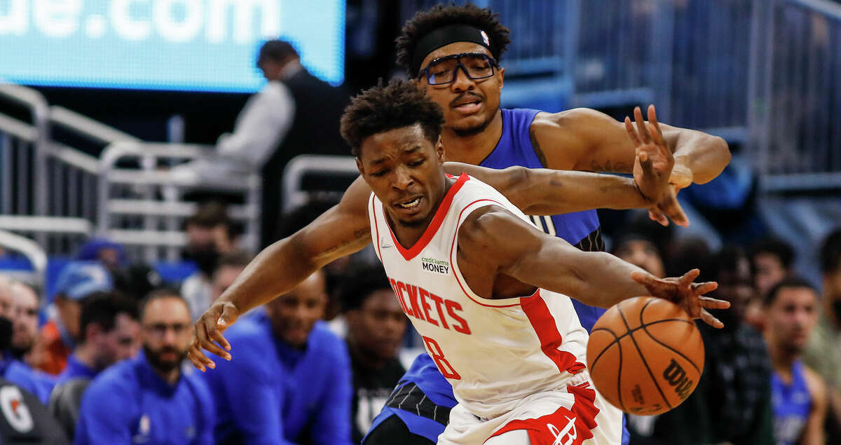 Houston Rockets forward Jae'Sean Tate, front, steals the ball from Orlando Magic center Wendell Carter Jr. during the first half of an NBA basketball game, Friday, Feb. 25, 2022, in Orlando, Fla. (AP Photo/Jacob M. Langston)