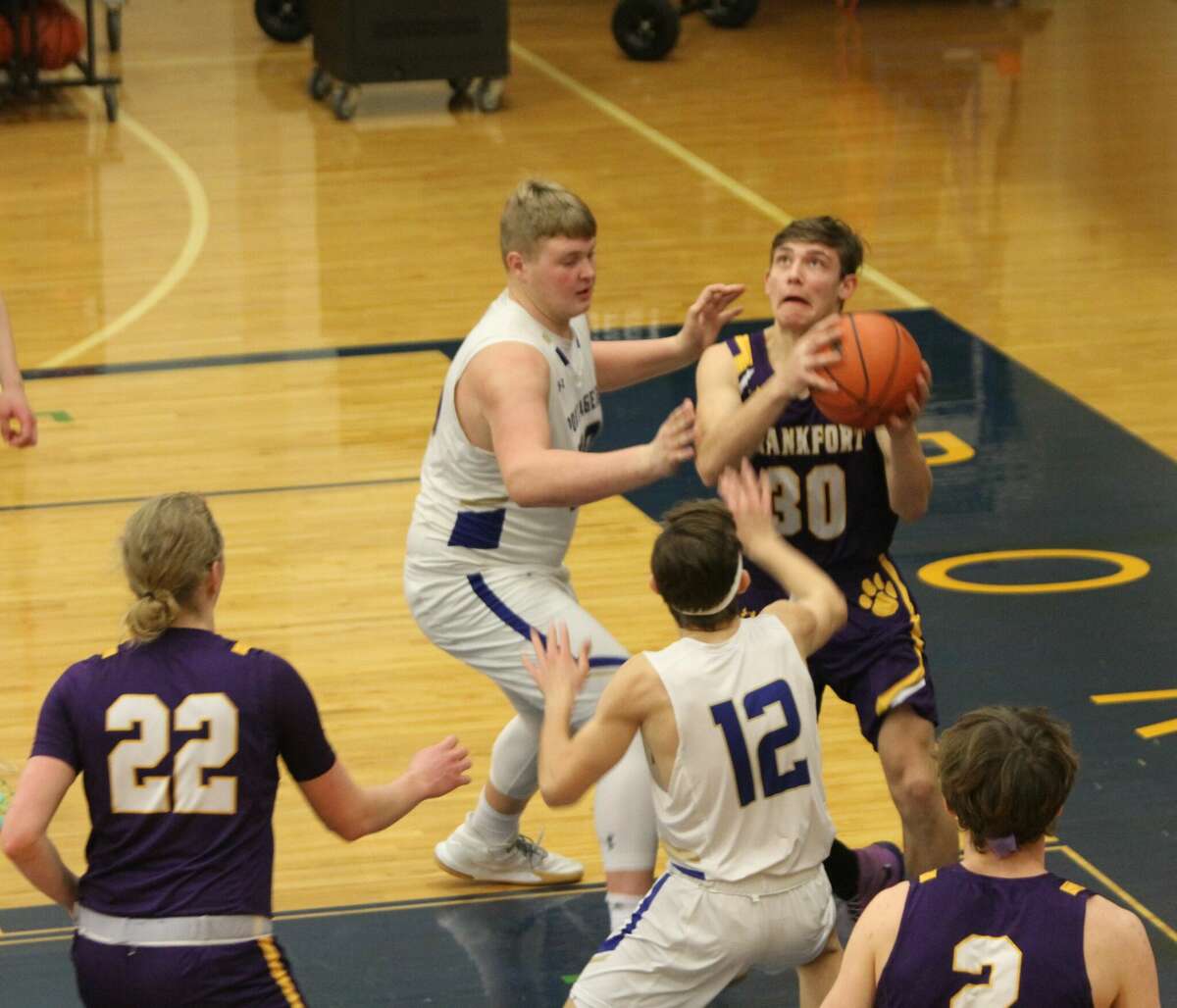 Frankfort junior Xander Sauer decides to pass instead of shoot the ball against Onekama on Friday, Feb. 25 at Onekama High School.