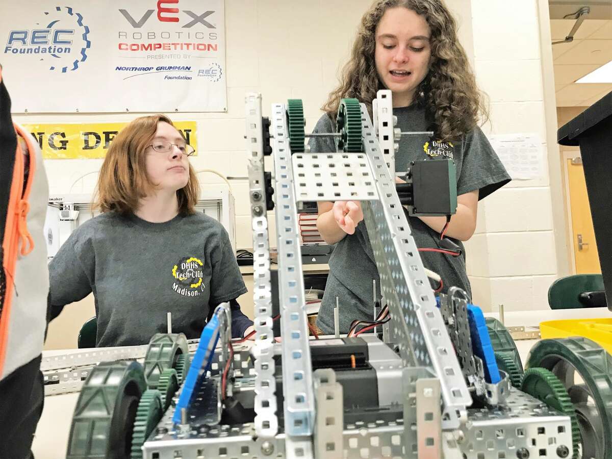 Hand, Senior, Caitlin Rosinus and Junior, Kelsey McEwen, discuss changes to their robot.
