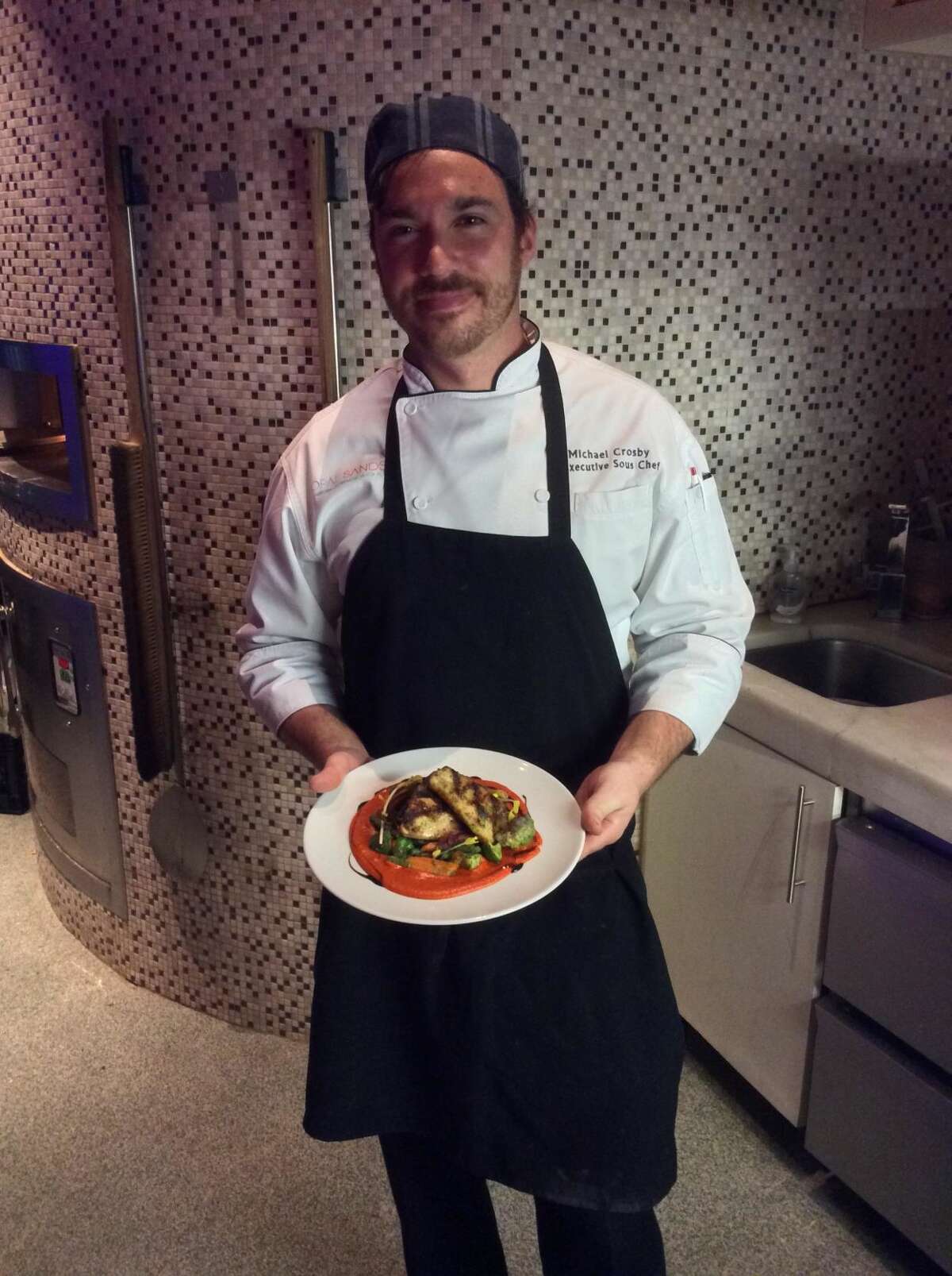 Chef Mike Crosby of Sea-Guini shows off grilled Cobia, served with a pesto roasted vegetable medley and smoked almond romesco, and aged balsamic.