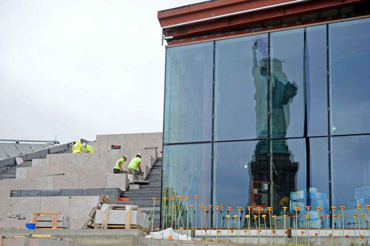The Statue of Liberty is reflected in the windows of the new Statue of Liberty Museum, which will open on Thursday, May 16, 2019 opposite the statue on Liberty Island in New York Harbor. The stairs and walkways visitors will walk on as they go to the museum are Stony Creek granite from the historic Stony Creek Quarry in Branford. Stony Creek granite also was what was used for the Statue of Liberty's pedestal -- and has sat beneath the statue since it opened on Oct. 28, 1886.