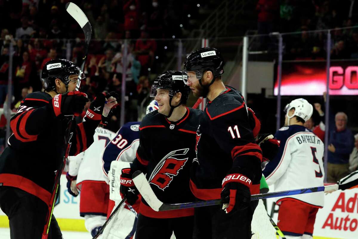 Carolina Hurricanes' Jordan Staal (11) is congratulated on his goal by teammates Jesper Fast (71) and Nino Niederreiter (21) during the second period of an NHL hockey game against the Columbus Blue Jackets in Raleigh, N.C., Friday, Feb. 25, 2022. (AP Photo/Karl B DeBlaker)