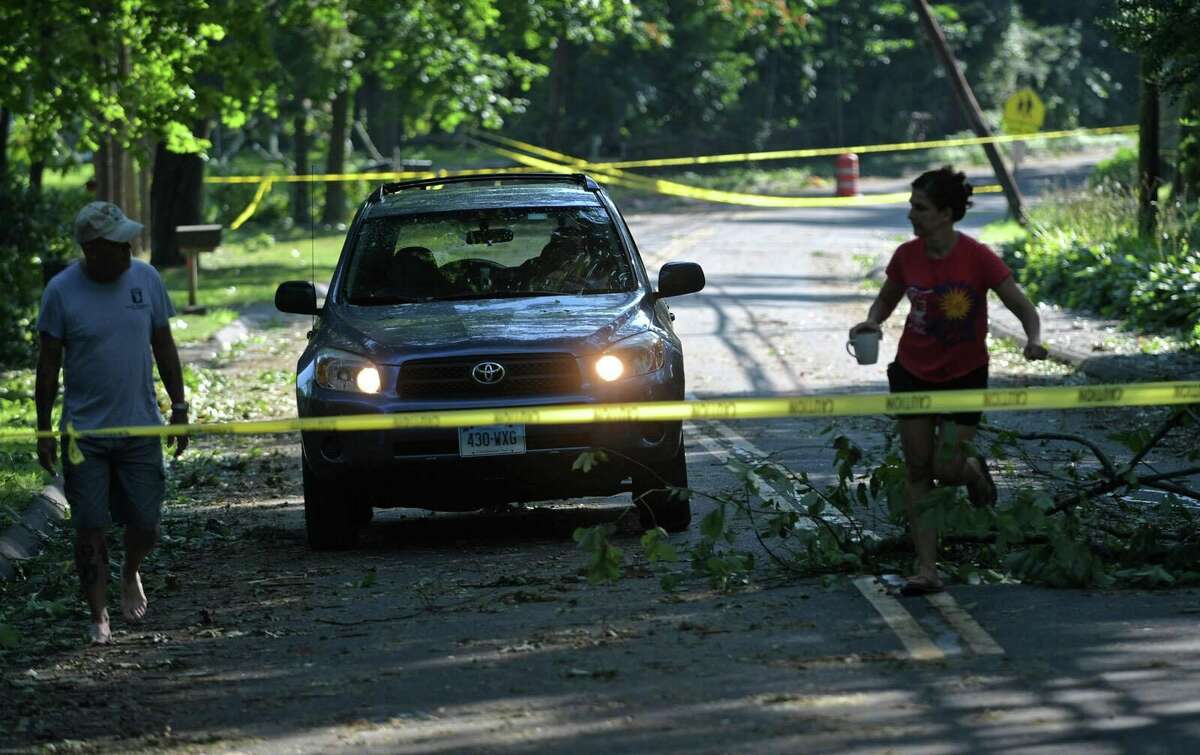 Residents on Ponus Ave emerge to find damage wrought by tropical storm Isaias Wednesday, August 5, 2020, which brought down trees with wind gusts up to 70 miles per hour in Norwalk, Conn.