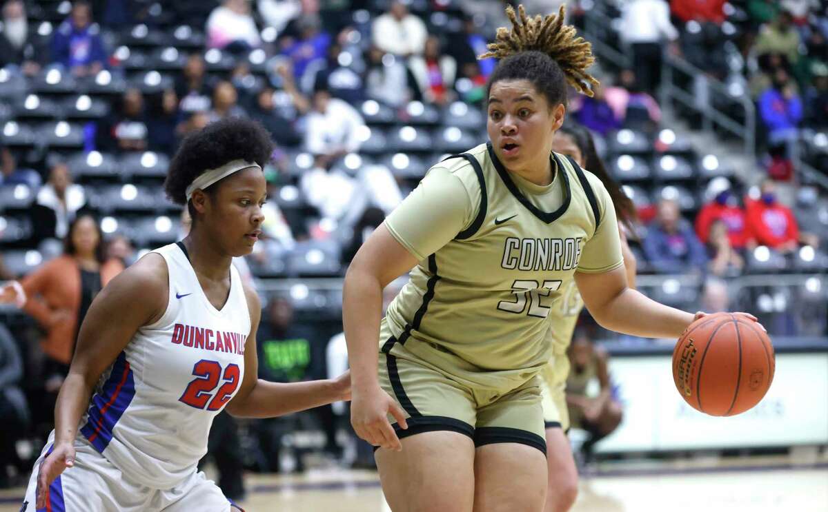 Conroe’s Isabella Stafford (32) handles the ball as Duncanville’s Kierston Russell (22) defends in the semifinals of the Regional II-6A girls basketball tournament at Davis Fieldhouse Friday, Feb. 25, 2022, in Dallas, Texas. Duncanville defeated Conroe 72-48 (AP Photo/Ron Jenkins)
