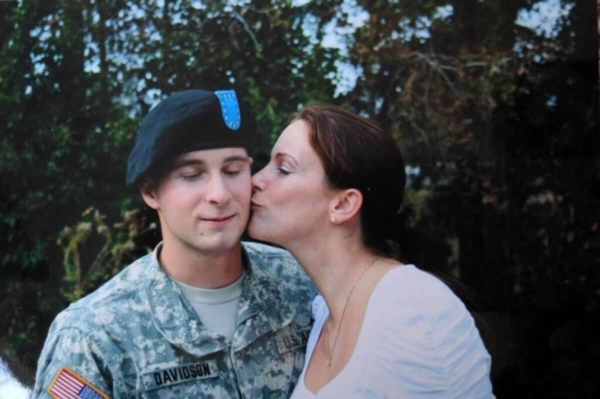 Donna Chapman gives her son, Sgt. William Davidson a kiss. Davidson struggled with mental health disorders after his deployment in Afghanistan and killed himself in 2017.