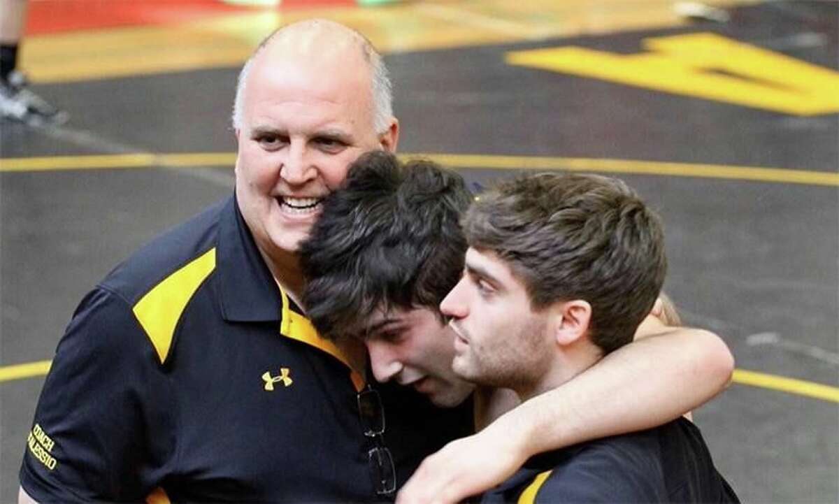 The late Daniel Hand High School Wrestling Coach Dave D’Alessio with brothers, Zac Santoemma and Luke Massella. D’Alessio died March 8 of cancer.