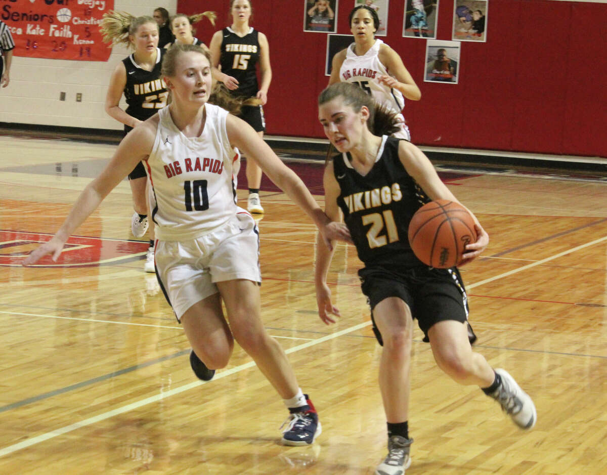 Big Rapids' Kate Langworthy tries to stop Tri County's Mary Shepard from going to the basket in CSAA Gold action on Friday.