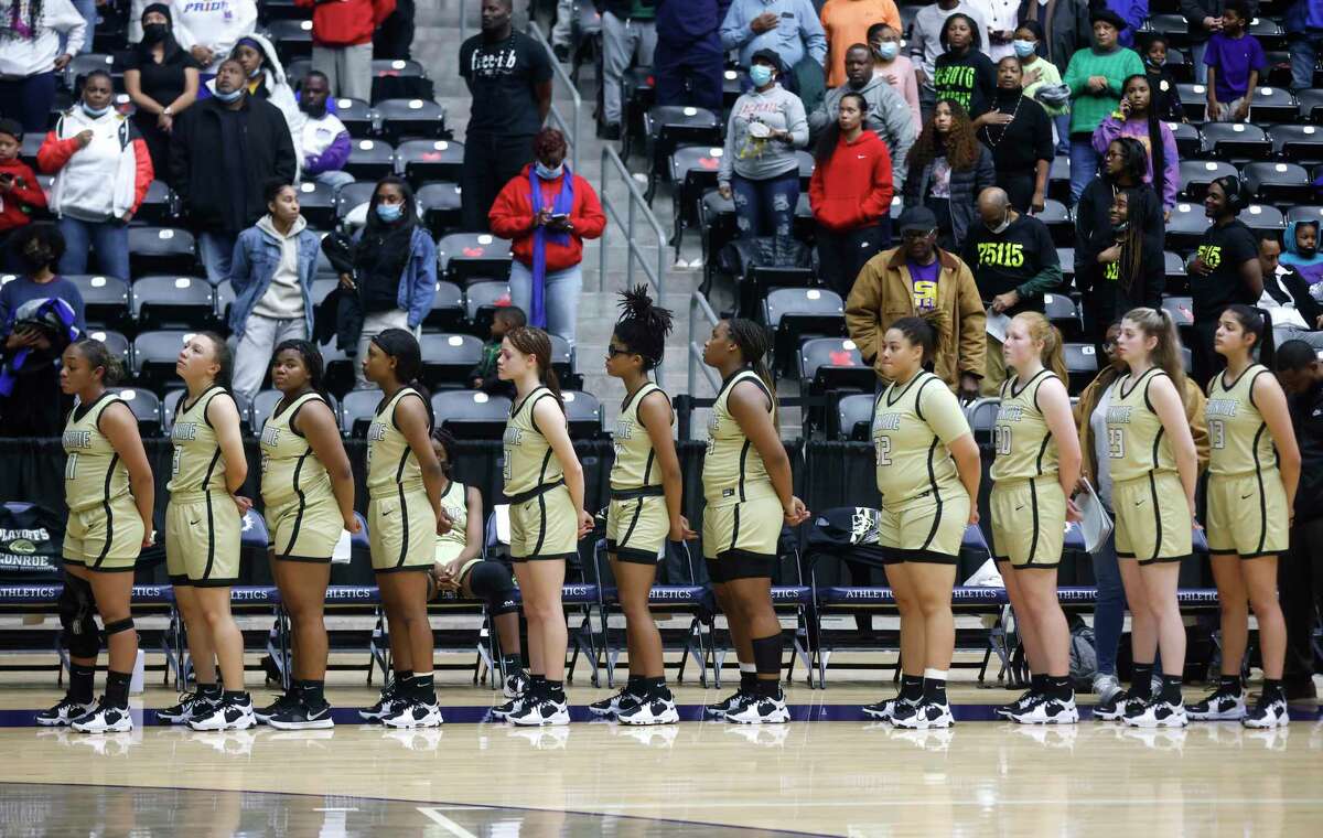 Conroe stands for the national anthem before playing against Duncanville during the semifinals of the Regional II-6A girls basketball tournament at Davis Fieldhouse Friday, Feb. 25, 2022, in Dallas, Texas. (AP Photo/Ron Jenkins)