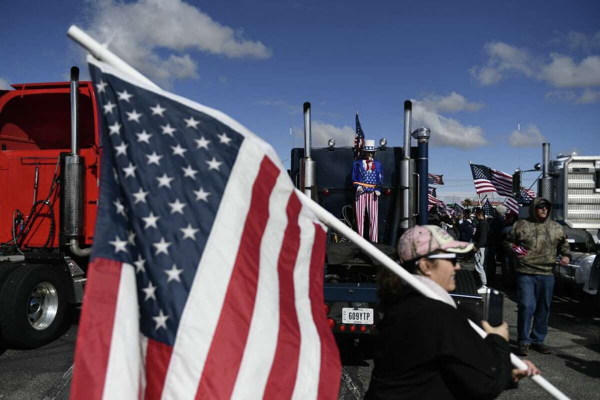 A figure dressed in the likeness of Uncle Sam is displayed on the back of a truck during a rally with truckers at the start of The Peoples Convoy protest against COVID-19 vaccine and mask mandates.