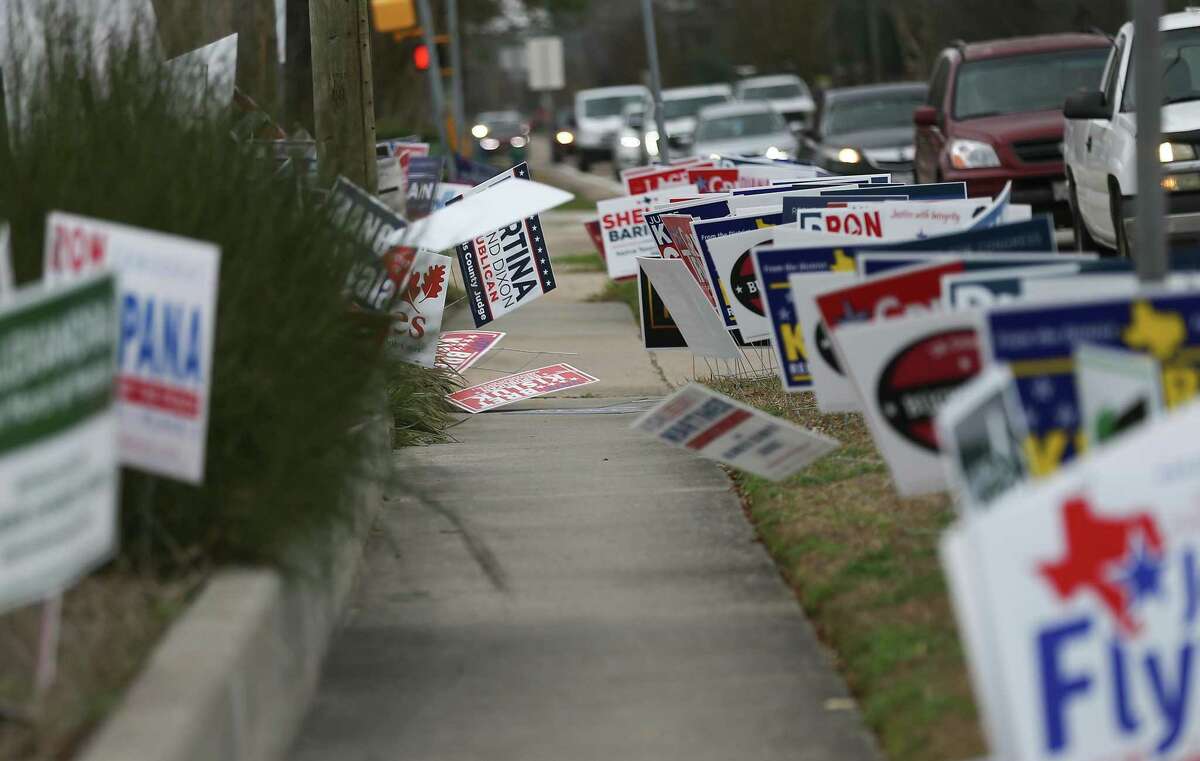 Election signs line the sidewalk outside Trini Mendenhall Community Center during early voting on Tuesday, Feb. 22, 2022 in Houston.