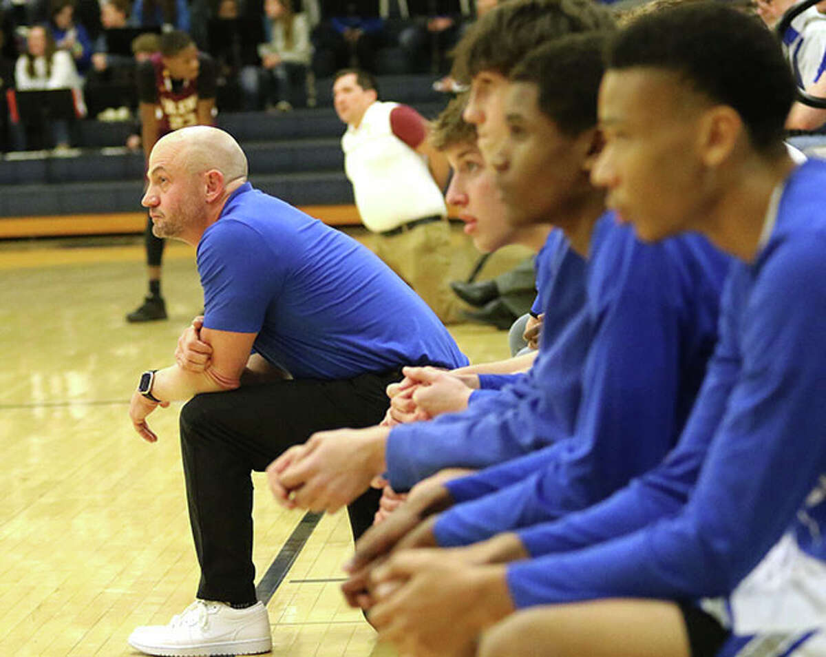Marquette Catholic coach Steve Medford (left) watches his team semifinal win over EA-WR on Wednesday at the Greenville Class 2A Regional. The Explorers were back in Greenville on Friday and defeated the host Comets for the regional title.
