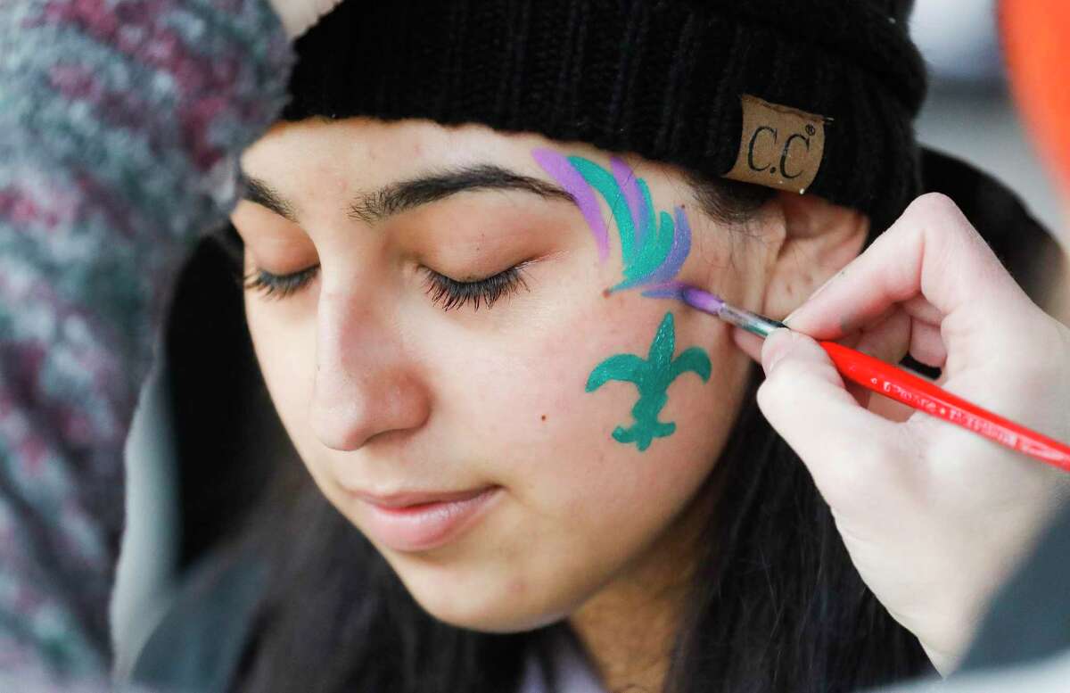 Isabella Trujillo gets her face painted with a Mardi Gras theme during Montgomery County Food Bank’s inaugural Outrun Hunger fun run at Grand Central Park, Saturday, Feb. 26, 2022, in Conroe.