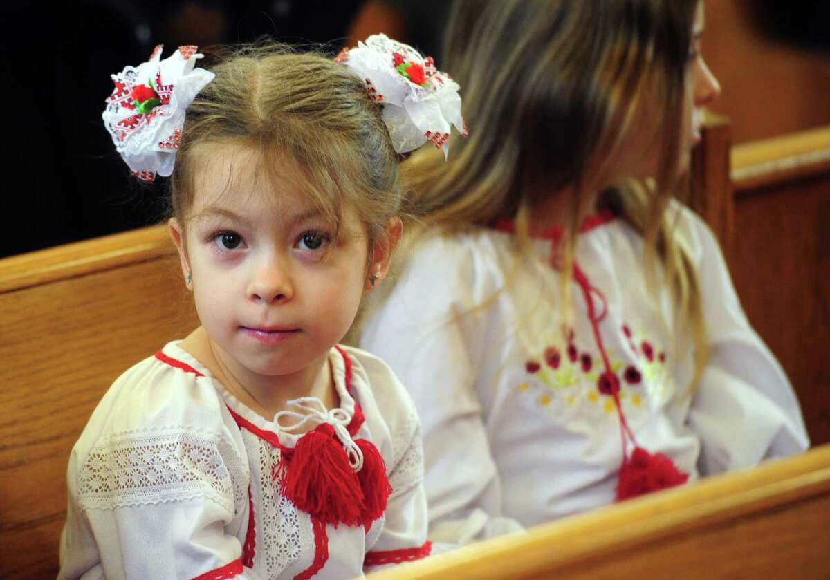 Maya Kuzmych, 6, attends a service at Saint Vladimir's Cathedral in Stamford, Conn., on Saturday February 26, 2022. The large and vibrant Ukrainian American community in Stamford gathered this morning to pray for peace in Ukraine. Many children of Ukrainian descent who regularly attend the School of Ukrainian Studies weekly on Saturdays and those who are members of the Stamford branch of the Ukrainian American Youth Association were at the service as well.