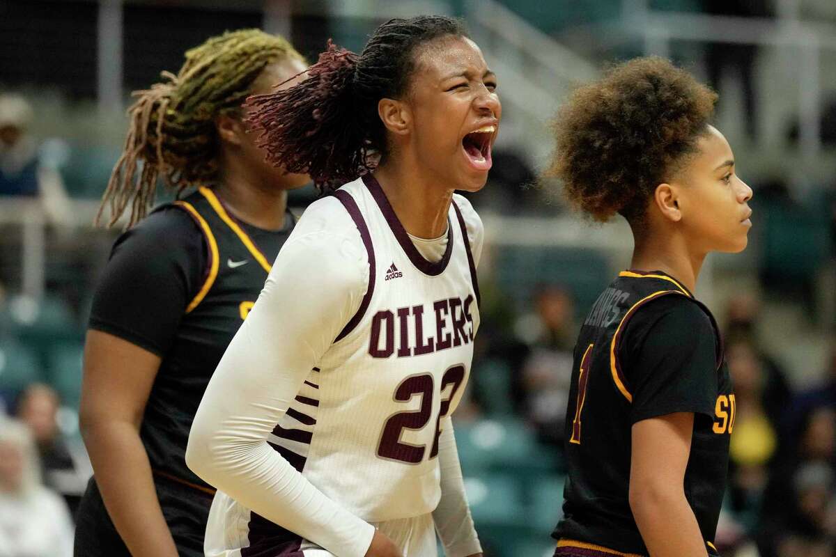 Pearland forward Rylee Grays, center, reacts after making a basket and drawing a foul during the second half of the Region III-6A high school basketball championship game against Summer Creek, Saturday, Feb. 26, 2022, in Katy, TX.