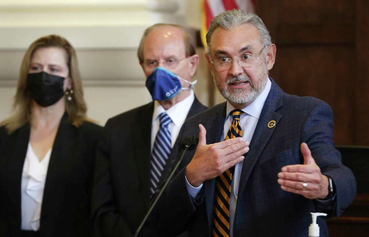 Bexar County District Attorney Joe D. Gonzales announces he’s formed a civil rights division with, center, Bexar County Judge Nelson Wolff and left, Christine Del Prado, then chief of the DA's special crimes division. She is one of 11 of Gonzales’ prosecutors who are running for judge seats this year.