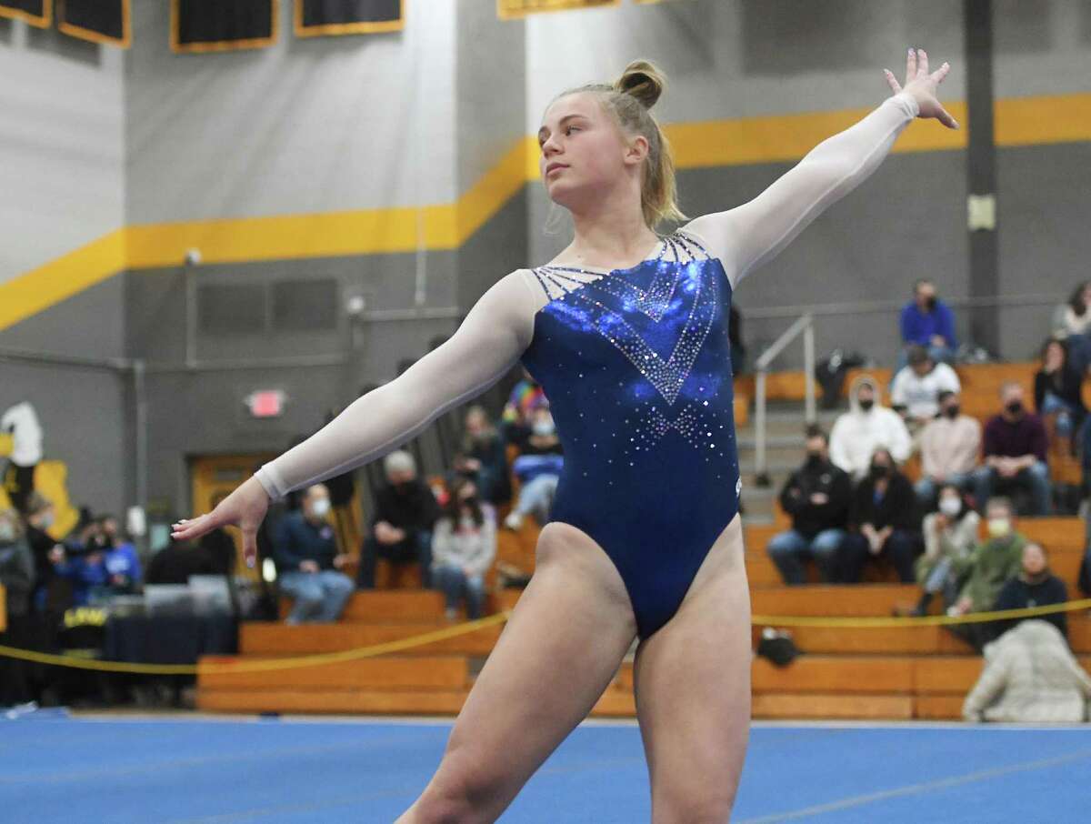 Staples' Mia Guster scores an 8.85 on the floor exercise at the Class L gymnastics championships at Jonathan Law High School in Milford, Conn. on Saturday, February 26, 2022.