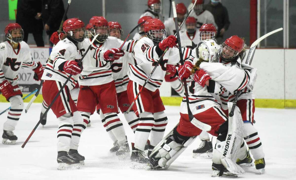 New Canaan celebrates after winning the FCIAC girls hockey championship over Stamford/Westhill/Staples on Saturday.