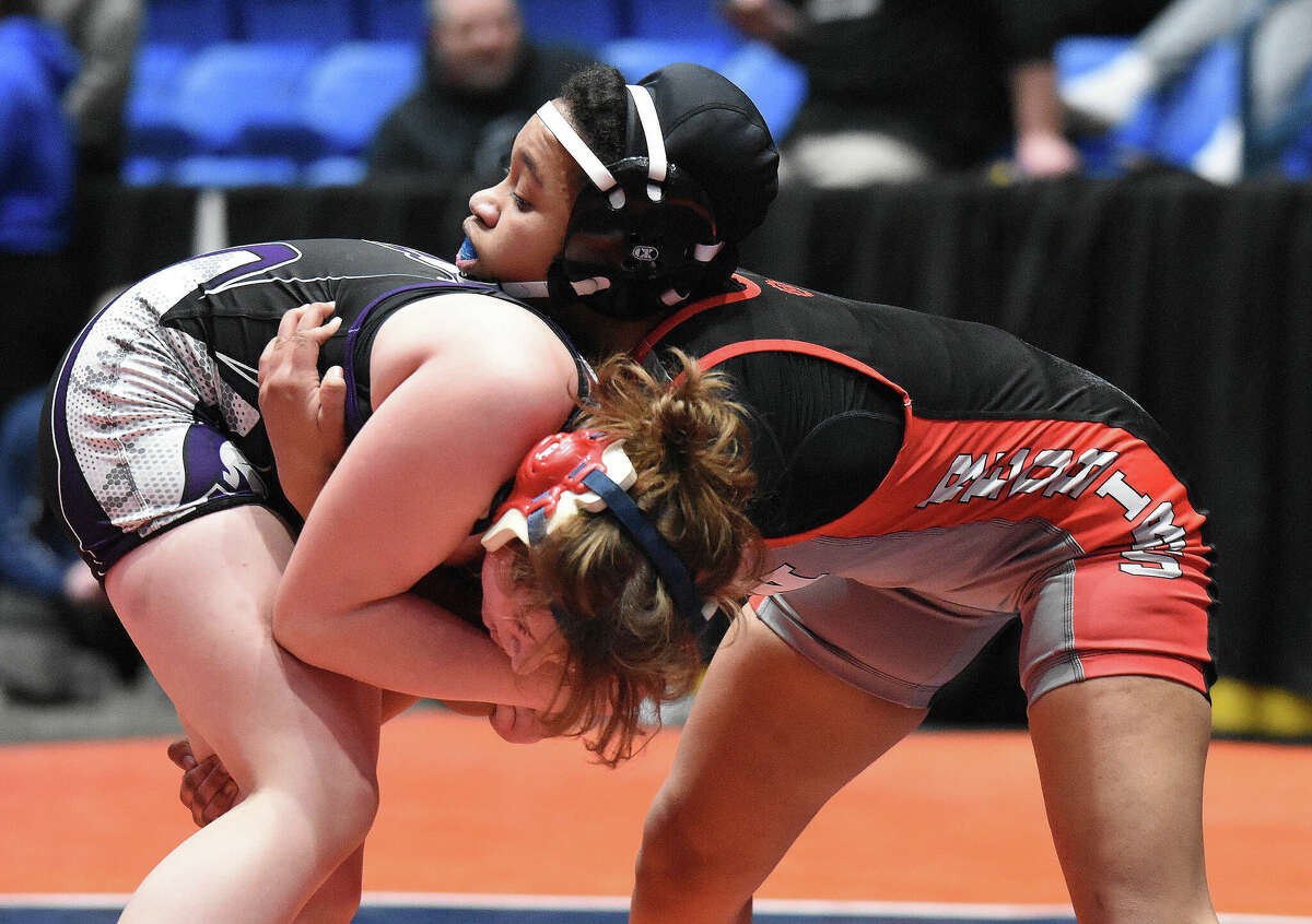 Alton's Antonia Phillips, right wrestles against Savannah Hamilton of El Paso in the 140-pound championship bout at the IHSA Girls Individual State Tournament Saturday in Bloomington. Phillips won the state title with a 6-2 victory.