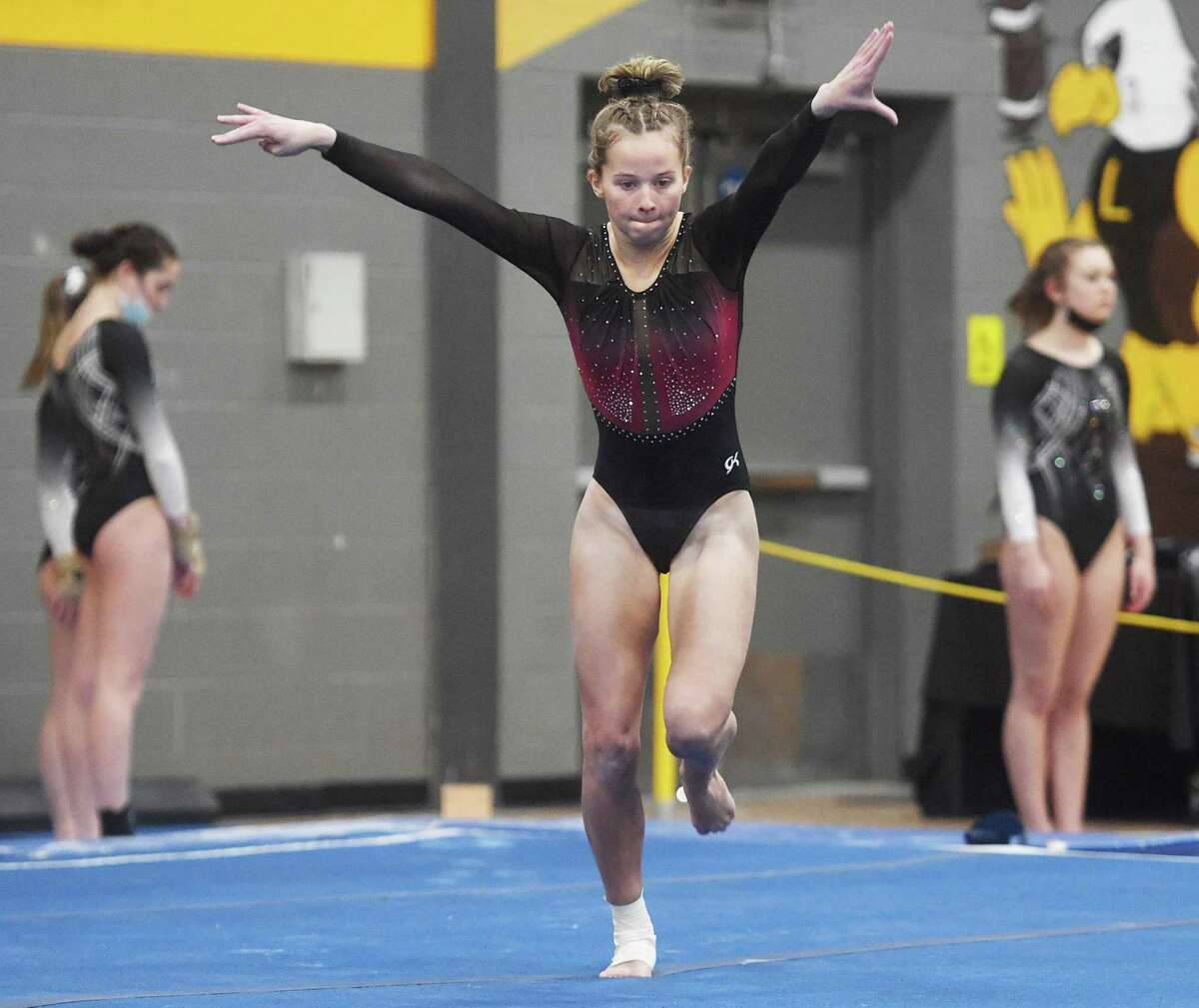 Fairfield Warde's Caroline Garrett competes in the floor exercise at the Class M gymnastics championships at Jonathan Law High School in Milford, Conn. on Saturday, February 26, 2022.