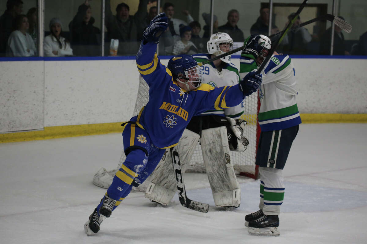 Midland's Braylen Laverty celebrates after the winning point in double overtime during a regional semifinal game against Saginaw Heritage Saturday, Feb. 26, 2022 at the Saginaw Bay Ice Arena.