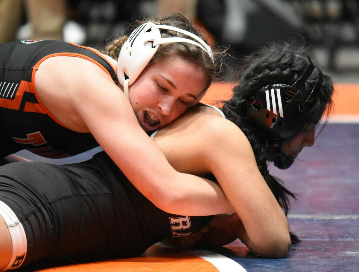 Edwardsville's Abby Rhodes, top, holds down Bolingbrook's Katie Ramirez-Quintero in a consolation semifinal match of the 130-pound bracket at the state tournament on Saturday in Bloomington.