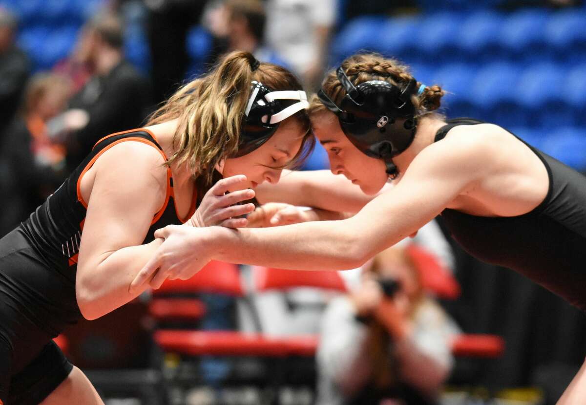 Edwardsville's Mackenzie Pratt, left, battles Freeport's Cadence Diduch in the championship match of the 120-pound bracket at the state tournament on Saturday in Bloomington.