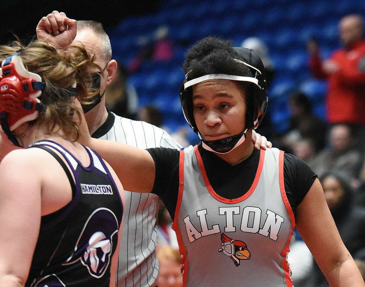Alton High School junior Antonia Phillips has her arm raised by a referee after she won the 140-pound state championship Saturday at the first Illinois High School Association Girls Individual Wrestling Tournament at Grossinger Motors Arena in Bloomington. Phillips, who is deaf, is the first state wrestling champion from Alton High.