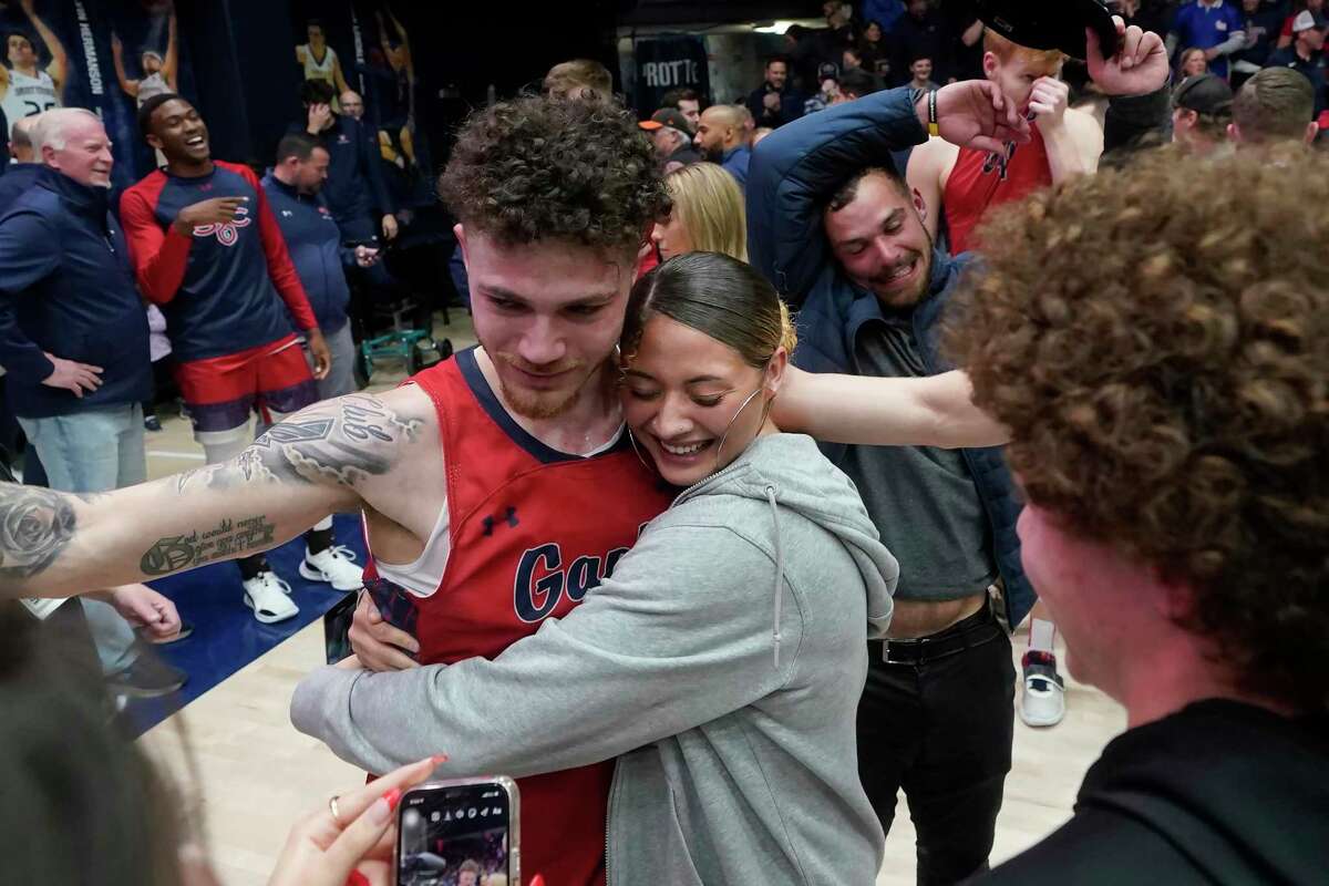 Saint Mary's guard Logan Johnson, left, is congratulated after Saint Mary's defeated Gonzaga in an NCAA college basketball game in Moraga, Calif., Saturday, Feb. 26, 2022. (AP Photo/Jeff Chiu)